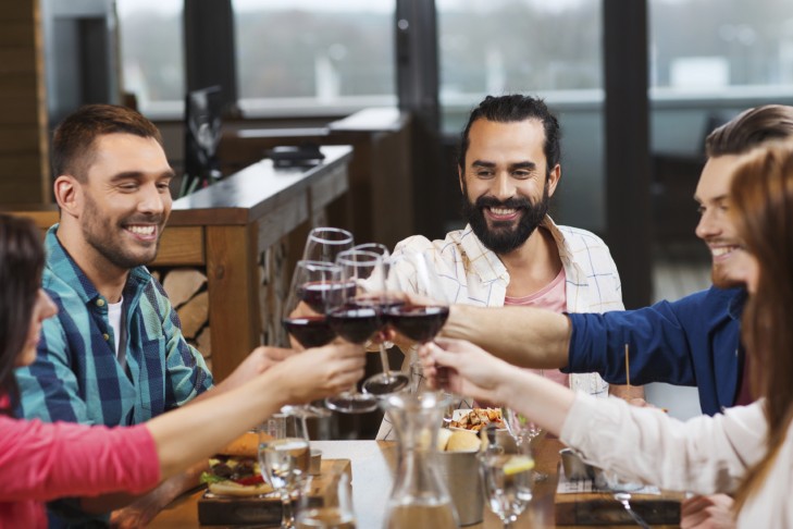 Friends dining and drinking (Photo: dolgachov/iStock)