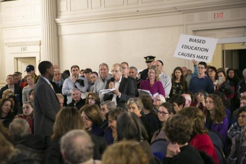 Newton Mayor Setti Warren, left, took a question from Charles Jacobs at a community discussion on making sure Newton is a welcoming place for all, at an event on April 7. (KATHERINE TAYLOR FOR THE BOSTON GLOBE)