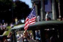 A man waves an American flag in the Independence Day parade in Barnstable. (MIKE SEGAR/REUTERS)