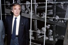 Nobel laureate and writer Elie Wiesel stood in front of a photo of himself and other inmates that was taken at Buchenwald in 1945. (SVEN NACKSTRAND/AFP/GETTY IMAGES/FILE 1986)