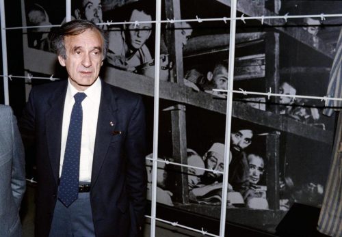 Nobel laureate and writer Elie Wiesel stood in front of a photo of himself and other inmates that was taken at Buchenwald in 1945. (SVEN NACKSTRAND/AFP/GETTY IMAGES/FILE 1986)