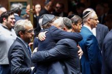 People embraced outside the Fifth Avenue Synagogue during the funeral for Elie Wiesel on Sunday. (KENA BETANCUR/AFP/GETTY IMAGES)
