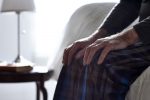Senior man sitting on bed with his hands on knees (Photo: Dean Mitchell/iStock)