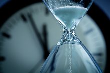 Time passes through the hourglass and on the clock (Photo: YinYang/iStock)