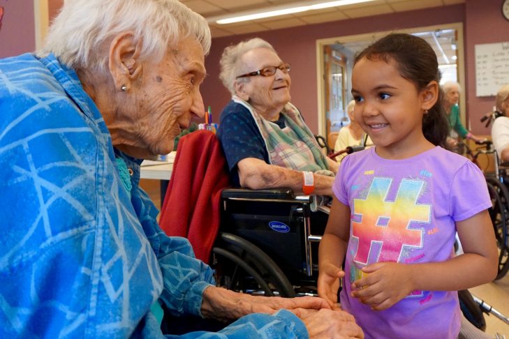 A senior at Hebrew Rehabilitation Center in Roslindale interacts with a local preschool student. (Courtesy Hebrew SeniorLife)