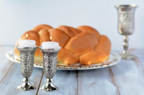 Shabbat candles with Challah bread and wine cup