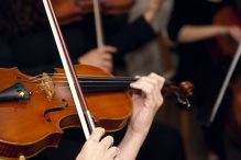 Violinists in the orchestra (Photo: Juanmonino/iStock)