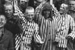 The documentary “Etched in Glass The Legacy of Steve Ross” shows Ross (third from left), a Holocaust survivor, at Dachau, one of the Nazis’ concentration camps.