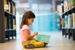 Young girl reading in the library (Photo: Tashi-Delek/iStock)