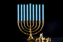 Hanukkah menorah with dreidel and chocolate coins (Credit: iStock/Randall_E)
