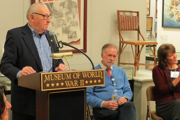 Izzy Arbeiter, past president of the American Association of Jewish Holocaust Survivors of Greater Boston, addresses a group of Holocaust survivors while Kenneth Rendell, International Museum of WWII director and founder, and Sue Wilkins, International Museum of WWII educational director, look on. (Courtesy photo)