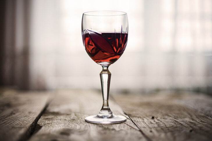 Red wine in glass on a rustic table
