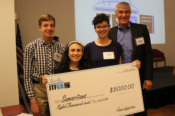 From left: Joel Goodman, Gavi Azoff and Shira Bloom present Steve Mongeau, executive director of Samaritans, with an $8,000 grant at the end-of-the-year celebration. (Courtesy photo)