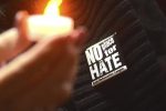 Referral use only - Holding electric votives and wearing pins from the Anti-Defamation League, about 600 attend a gathering at Knesset Israel in Pittsfield, Mass. for an Interfaith Community Vigil on Thursday, Nov.  1, 2018, honoring the lives lost at the Tree of Life Synagogue in Pittsburgh. (Gillian Jones/The Berkshire Eagle via AP)