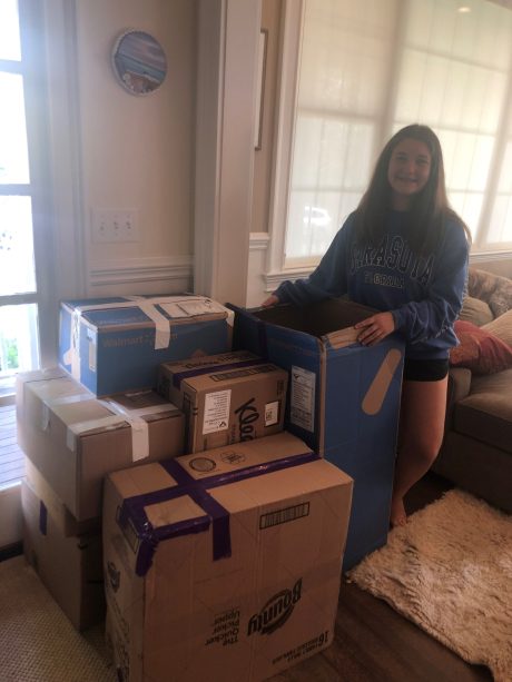 Ava with some of the boxes of supplies she collected for the project (Courtesy photo)