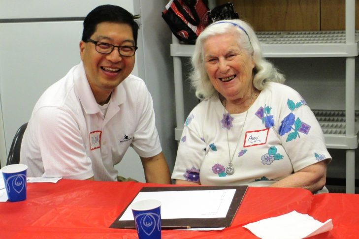 A volunteer sitting with a guest at a memory cafe (Courtesy photo)