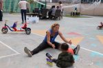 Lucia Carballo Panichella plays with a child in San Diego (Photo: Craig Byer/CJP)