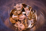 Dreidels and Gold Coins (Photo: iStock/Izzet Safer)
