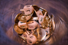 Dreidels and Gold Coins (Photo: iStock/Izzet Safer)