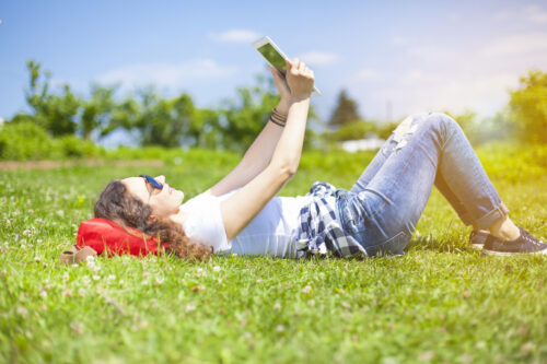 Teen young woman outdoors using technology tablet computer (Photo: eternalcreative/iStock)