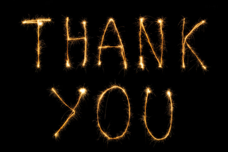 close up view of thank you light lettering on black backdrop