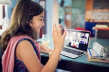 Schoolgirl is e-learning and video conferencing at home