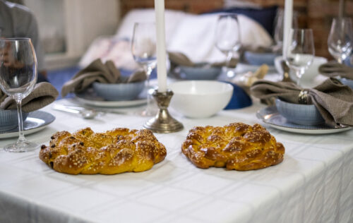 Warm fresh baked Jewish challah bread on a table