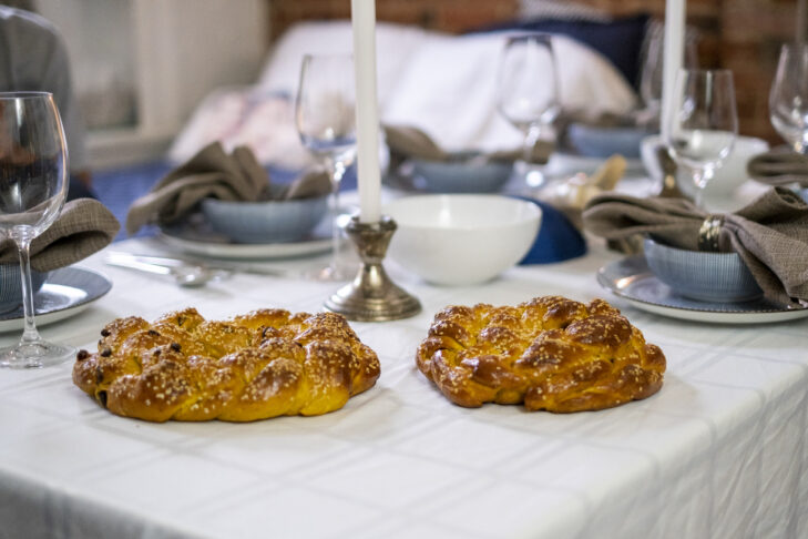 Warm fresh baked Jewish challah bread on a table