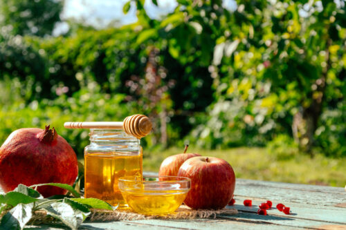 Apple and honey and pomegranate, traditional food of jewish New Year - Rosh Hashana. Spacefor text