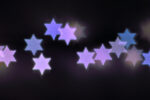 Beautiful bokeh lights in shape of the Star of David for Hanukkah celebration. Jewish Holiday background.