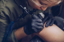 Woman getting tattoo in studio