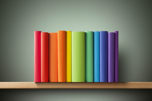 Colored books on the shelf.