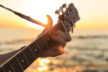 Young guy playing a guitar at sunset(Soft Focus)