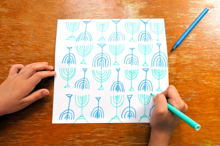 POV of a child drawing a Menorah shapes on a card for Hannukah Jewish  Jewish holiday.POV of a child drawing a Menorah shapes on a card for Hannukah Jewish  Jewish holiday.