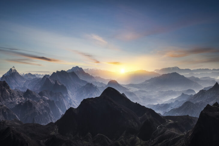Aerial view of misty mountains at sunrise