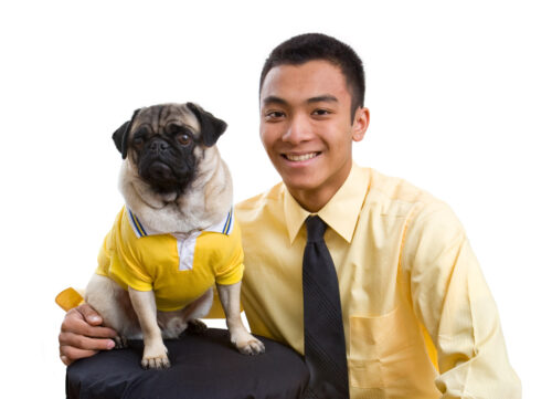 "a teenage boy with his dog, both wearing yellow outfits"