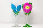 Two wine glasses with flowers paintings.