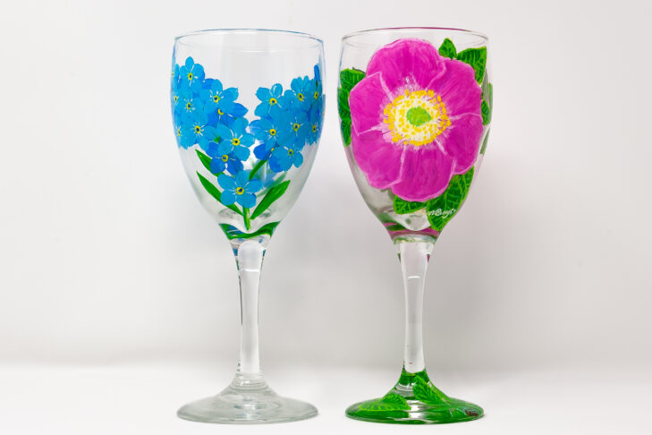 Two wine glasses with flowers paintings.