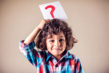 Kid boy with question mark. Children, education and emotions concept Kid boy with question mark. Children, education, emotions concept