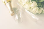 Wedding concept. Champagne glasses and roses bouquet