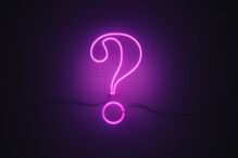 Question Mark Symbol Drawn by Purple Neon Light on Black Wall Question mark symbol drawn by purple neon light on black wall. Horizontal composition with copy space.