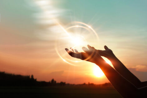 Woman hands praying for blessing from god on sunset background Woman hands praying for blessing from god on sunset background