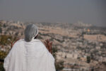 Jerusalem, Israel - October 31, 2013: Ethiopian Jewish woman prays, facing the old city, at the Sigd in Jerusalem, Israel. The Sigd is an annual holiday of the Ethiopian Jews.