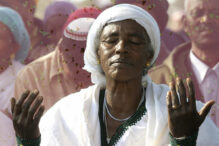 JERUSALEM, -:  An Ethiopian Jewish woman prays during the "Sigd" holy day, on a hill overlooking Jerusalem, 24 November 2003. The traditional prayer is performed by Ethiopian Jews every year to celebrate the biblical union between the Jewish people and God.  AFP PHOTO/GALI TIBBON  (Photo credit should read GALI TIBBON/AFP via Getty Images)