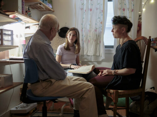 15 MAR, 2022: BROOKLYN, NEW YORK: Noma (C) prepares for her bat mitzvah, reading the Torah in her bedroom with her grandfather, Rabbi David Klein, and her Aunt Shira. CREDIT: SARAH BLESENER FOR NPR