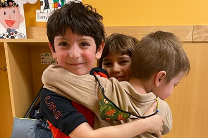 3 kindergarten boys hugging
