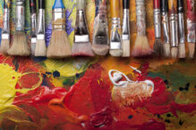 Paint brushes in a row,pallete at background,studio shoot