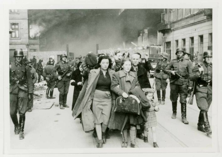 Jews captured during the suppression of the Warsaw ghetto uprising are marched to a holding area prior to deportation. Warsaw, Poland, 1943. National Archives and Records Administration