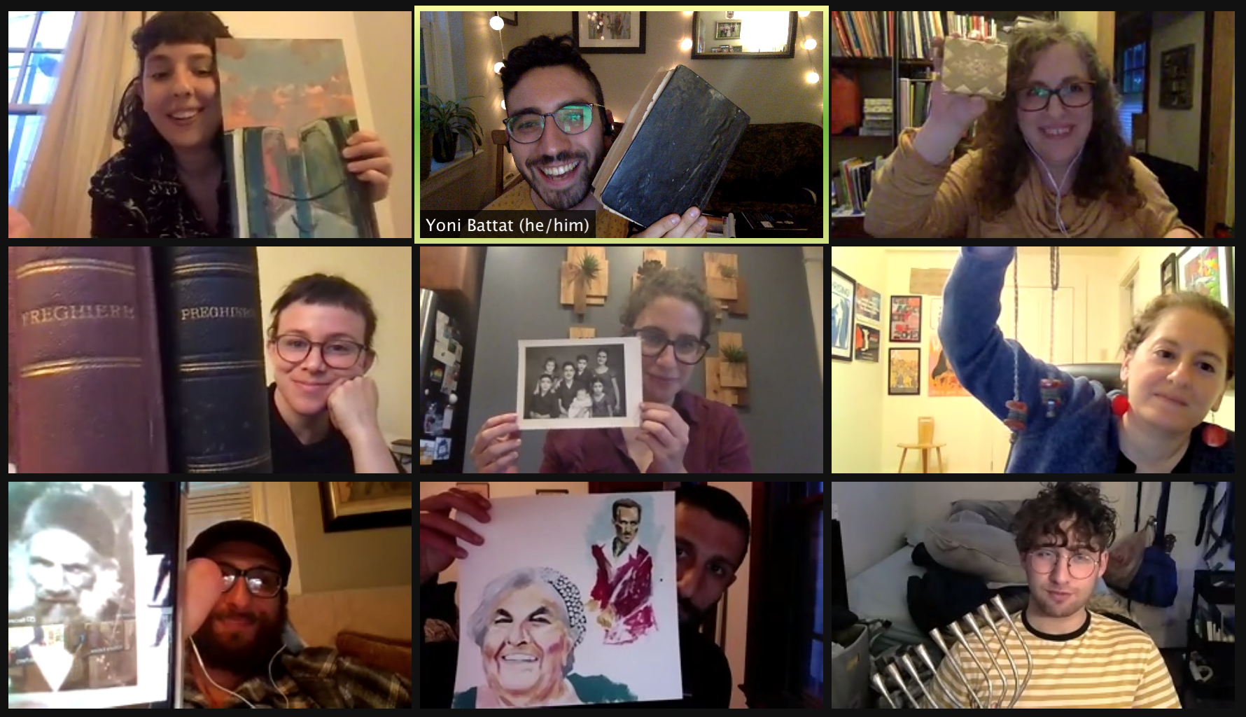 Nine people hold up artwork on a Zoom call