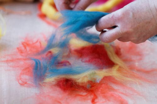 Woman prepares the wool for wet felting process
